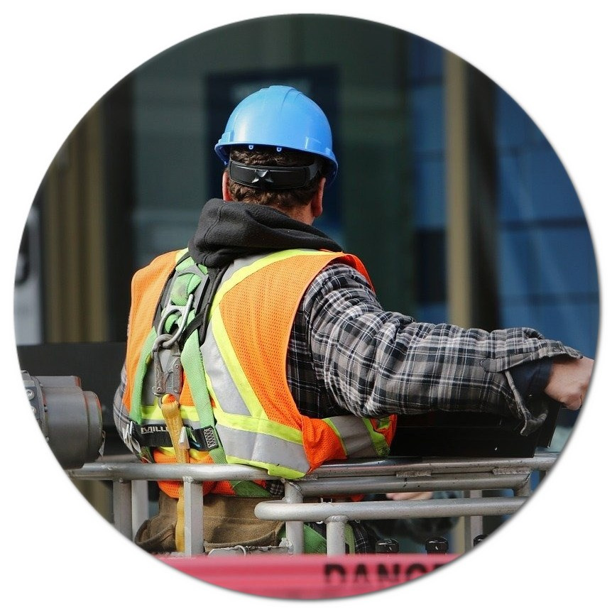 A construction worker wearing a hard hat and safety vest.